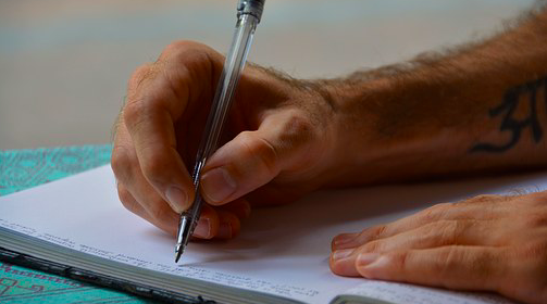 A person writing a report